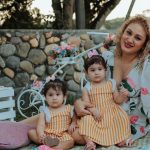 A joyful family picnic in La Dorada, Colombia featuring a mother and her two children outdoors.